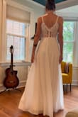 I bought this dress for my backyard wedding. Its simply and flowy and the transparent lace panel on the back adds an elegant touch. The skirt has two layers and the top layer is slightly transparent and twirls well. The buttons on the back are not flush with the fabric on the back because of the way they are shaped, but its not noticeable. This dress is affordable and beautiful. - Althea K.