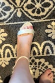 Purchased these as potential wedding and/or bridal shower/engagement photo shoes. I'm a pretty true 9.5 but do own some 10s. My feet are somewhat narrow with pretty flat arches and pretty skinny ankles. Since Lulus doesn't make 9.5, I ordered a 10. The ankle strap could actually be adjusted small enough, which is uncommon for me, but the part over the toes was way too high, and the part on the back of the heel was awkwardly far away from my ankle. I think it would've been too loose in the front even if I could go down a half size. I can't speak to durability or comfort since they were too big. Sadly I'll have to return them. - Laura H.