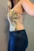 This is such a beautiful top! Although I was a little nervous about purchasing because of my bigger bust size and the "corset" like cups, it fit so well and was form-fitting in the best way. The embroidery is even more beautiful in person, and I loved the sheer back. The front and cups are lined well, making the contrast with the sheer back even more standout. I would definitely recommend it. I wore it for my birthday and got lots of compliments on how unique it was! - Erin S.