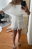 The size fits just right and with certain poses it looks great, but when you lift your arms the top layer flares up and looks so awkward. - Alexia G.