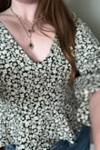 I recently purchased this adorable top for a fun, flirty blouse to wear on date night or a day off and I love it. I'm usually a size 6 or an 8 and wear Mediums in most of my clothes but with Lulus tops I'm finding size Large tends to be the way to go for me. I have broad shoulders. A bra is optional. I love that you can tighten the corset straps if needed. The shirt is a lovely olive green. Not wearing a bra in either picture! - Jenna M.