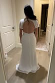 Liked how the flutter sleeves balanced out the dress.  The back is super cute.  I am a couple months from my ceremony, this will fit perfectly by then! - Adrienne N.