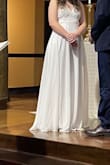 If you're looking for a simple white dress with a lace top, this dress is beautiful!! The straps are adjustable and crisscross on the back. I love the way the dress falls when touching the ground, and it is very comfortable! I will say it was very long but when wearing heels, it was the perfect length. - Paige S.