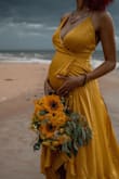 This dress was right on time! It fit well! It was flowy and comfortable. It is made out of nice material. It adjusts to your body with the string in the back. - Zella H.