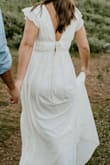 This dress was exactly what I was looking for to take engagement photos. Definitely runs long (I'm 5'3"), so I should have tailored it, but it worked fine for the shoot. If I were to wear for a formal event, it would definitely need to be taken up by a few inches (even with heels), but that's pretty standard at my height. I had ordered in both XS and S, and the XS was definitely too tight around the waist and butt (there's a more fitted liner), but the S could have been just a bit tighter on the bust and sleeves, which do have little rubber pieces to help keep them up. Overall, it worked great, and I got a ton of compliments! - Blayke R.