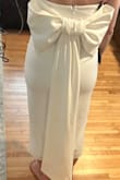 This dress is cute but was not super flattering on me. It is also very heavy and the bow requires an extra person to snap it on. - Rachel M.