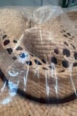 It came in crushed. I didn't even take it out of the bag and you can see it. I was really looking forward to wearing this hat on my vacation. Better shipping packaging needs to be used for hats. - Karen T.