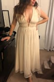 The dress was beautiful. The color is a little more cream tone in person than the photo on the website. The sizing ran larger than anticipated around the shoulder and any movement cause it to fall off. As a quick fix I used double sided tape to keep the dress from falling down. With the right alterations it'll fit perfectly. I'm also 5'2" so it fell longer on me but had no issues with where the length landed. I ordered a large but if time permitted I wouldn't have swapped it for a medium. Love the dress! - Jennifer M.