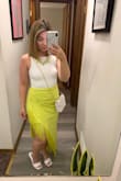 I love this skirt! The color is one of my favorites and I also love fringe! I'm short so without a little heel the skirt would drag on the floor; Just an FYI. It fits very comfortably in the waist and I got a size M. I WILL say that the back will show every bit of your booty shape, so be ready for that if you're not fond of your behind because it's very fitted back there, lol! - Nikki L.