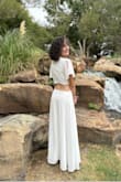 My daughter wore this to a dance and she looked so elegant. The fun open back gave extra pizazz to the dress! She received many compliments! It was long on her 5'5 frame and she has long legs. Even with a 2 inch heel we took off 5 inches at the bottom. Other than that it fit wonderfully. It was a bit see-through but she wore a beige bra and a beige slip and then it was perfect. - Mica M.