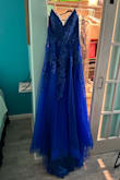 This dress is absolutely stunning in person! The color is even prettier in person and it fits perfectly. I love this dress. I can't wait to wear it to the ball in December. - Rebecca W.