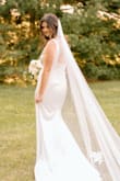The dress is of great quality and fits true to size. It does have some stretch to it so it fits curves nicely. The color is more ivory than true white. Very classy and was perfect for my intimate backyard wedding. - Alex P.