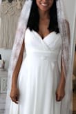 I am getting married on the beach, and I had some problems with the original dress I was going to wear. I got this one as a last minute solution. I was very surprised at how perfectly this dress fits my body. The only alteration I made was cutting the front length of the dress. I am 5'3" tall. 
The quality of the material is great, and the dress looks expensive. It is not see-through with the double layer. I added a dainty Clear Quartz belt that I got at an Etsy shop called Lina's Jewels. Customer service was excellent. I got two dresses to see which one fits me better. I called to return one of them, and customer service was very efficient. - Lina G.