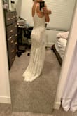 I think this is the one for my beach wedding next year! I own at least 20 other Lulus dresses and have tried a few of their wedding dress options. This one was the most true to size comparable to other dresses I've bought in XS. It fits like a glove, I may only have my mom replace the straps to be nicer and pull up the train some in the hemming. It feels and looks very high quality, while also being light to wear. The lace patterning is very intricate and looks great in photos. I've tried a few wedding dresses from other sites as well and this has been the best by far in the boho, Anthropologie-like style without the price tag. - Laura W.