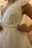 Good quality fabric. It fits well for the most part. The bust could be taken in a little but it wasn't too ridiculously loose so I just left it as is. I had my tailor shorten the front a bit. It's a great dress if you're a shortie because you get a free train pretty much. I made a simple overskirt to put on top and voila! Wedding dress under $250. - Siu M.