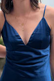 The S was slightly too tight in my rib cage, so I sized up and got a M tailored. If the S could have been taken out 1/2 inch even, I would have had room to dance and eat lol. Do with that what you will! The fabric photographs so well, and I got so many compliments (including from an 8 year old girl which made my entire night). I can't find a pic that actually shows the full dress in one photo, but tried to show the top and bottom. - Shelby P.