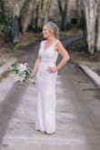 This dress fits amazingly. I ordered both S & M and the S was perfect; the only alteration needed was to add cups. I'm a true size 4 in clothes with an athletic runner's build. This fits like a glove and is very flattering. The color is exactly what I imagined for a second wedding at a winery. Definitely not white. The lace is gorgeous and the nude lining gives it the more cream/ivory look I wanted. It is simply stated and perfect. The quality and price are both incredible. Perfect for a beach or vineyard wedding. - Amanda B.