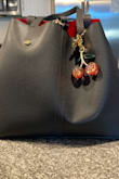 It's definitely a nice quality shoulder bag! It's not too big and very spacious. I wish it came with extra storage installed in the bag. The middle detachable bag is nice but isn't convenient because the zipper barely opens wide enough. Overall, it's very nice. I love it! - Lylah B.