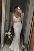 I love the weight of this gown. The cape is lovely and clings just right. I had the straps altered so they don't need to be adjusted and look more custom. I added some accessories and it is just lovely for our small elopement this winter. - Lindsey B.