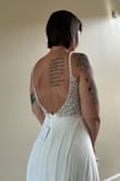 I bought this dress for our destination wedding in Barbados. It is super pretty and of amazing quality. The beading is very nicely done and the fabric is nice. I ordered a medium, but the top was too big, so I sized down to a small and it fits perfectly. The dress is very long, even with heels. I plan to have the front of the dress hemmed. I have included pictures of me in the small, I don't have a full-length photo yet. I got a great deal with a promo code, free shipping, and a super easy exchange process. - Nicole W.
