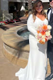 I was so worried these dresses wouldn't fit but they fit amazingly, I had the bottom tailored for my short height. The buttons go along the zipper and make the dress feel so glam and luxurious. I couldn't be happier! They added a garment bag complimentary which was very generous! Ships quickly as well. - Rebecca S.