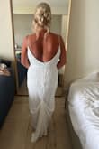 This dress is absolutely stunning. I ordered this for my destination wedding in Mexico. I fell in love immediately. The beading is beautiful. It felt a little heavy on the hanger but it is not heavy on. I needed it hemmed because the ceremony was on the beach so I was barefoot. I added a bustle but that was it for alterations. Fast delivery, great customer service, and great quality. I couldn't have purchased a more perfect wedding dress. - Danica P.