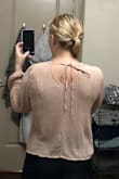 This shirt is appropriate for business casual (although not the most flattering) but the back is partially sheer so you will need an undershirt to wear with it. - Laura R.