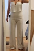 This jumpsuit was such a fun piece. I'm glad I tried it on, even though I didn't keep it. I'm very short so hemming was expected. The material was thin and slightly see-through. The bust stayed in place without a bra, but I only tried it on. Lower tummy and panty lines definitely show in this one, and it can fit tight around the crotch area. - Jamie L.