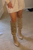 A great staple to have in your closet! Pros: great falls at a great length on me and stays structured. I have wider calves and it fits with no issues. Cons: the design "cut" I thought someone used a box cutter before I realized it was intentional. Almost returned it for that reason but I decided to keep it since it's so cute on and I don't really see it. You WILL need help getting the boots off as there is no zipper. - Kristina L.
