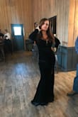 Is fitted tight in sleeves. I sized to a Med. Shoulders do fall and are made for taller model types. In order to get sleeves to fit your arms you would need to use black velvet ribbon to tie behind the neck to keep the dress from falling off shoulders and to not expose so much cleavage. - GINA T.