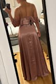 All in all very happy with this dress. The dusty rose color is exactly as pictured and super pretty for the August wedding I bought it for. It's definitely low cut but not outrageous with my bust. Comes very long (I'm 5'5 and wearing 3" heels in this photo) but that's easily fixed. A wrap dress is always a good bet since it's so adjustable! - Emilie P.