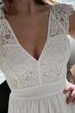 I got this dress for my rehearsal dinner as the bride. It is so gorgeous and the detailing at the top is of good quality and does not look cheap. The top is a little tight on my bust and armpits but I would not change the size due to the overall fit. It fits better with no bra and is not see-through. - Kasey D.