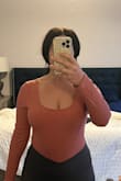 This top is soft and comfortable on my skin. The snaps on the bodysuit aren't too tight and I have a long torso. The color is slightly darker/muted than on the model but only when you're not in natural light. It runs a smidge big in the arms and waist. So if you have full arms/tummy this could work for you! It also has a lot more stretch than expected. Not too low-cut either. - Heather J.