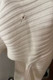 The dress came with tags on with a hole in it. The hole is on the thigh. Sweaters are hard to repair according to a seamstress, and it's too late for me to send it back and get a new one in time for my bridal shower. Also, they ran out of my size so I can't even order a new one before my shower. I'm really disappointed because without the hole the dress would be perfect. The hole looks so obvious, too. - Emily M.