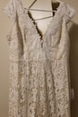 I bought this dress for a very small last-minute wedding. It was so pretty and arrived very quickly. For the price, I could not believe the quality. It was so perfect. The dress is a cream color. I have wider hips so I did order a size up. - Cayce D.