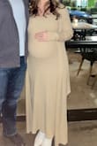 I wore this when I was 8 and 9 months pregnant and I LOVED it!!  So stretchy, soft, and comfy!  I'm normally a medium and sized up to a large to fit my belly.  The sleeves were a little long on the cardigan, but I would not have sized down.  Definitely order this one!! - Rachel F.