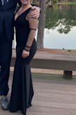 Hugged my curves in all the right places! I probably could have worn a Medium, but it wasn't in stock so I ordered the small. The quality of the material was thick, smooth, and didn't show any lumps or bumps. I wore platform heels and was able to get away without hemming the dress -which was a huge win. The tulle sleeves weren't itchy at all. Definitely a great addition to my formal options. - Sarah C.