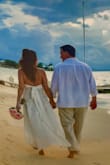 We quickly planned a destination wedding. I ordered many dresses online due to timing. This was my first arrival. I loved the dress for a beach wedding! I didn't love the back straps because it made unflattering bulges. Being 52, I also felt it came "too low" in [the] back for my age. There is absolutely no hold in the bust area. Dress is long. Found another dress but ended back at this dress because those who saw it said "You have to wear it!" My daughter suggested minor changes. With a week to go, cut the straps to make a halter, took the material from length and made a tie in back, left the hem fresh cut, added cups, and didn't even need to wear a bra! (Adjustments to dress: $70). The dress packed nicely. The dress was PERFECT! I received so many compliments from guests on the resort. The wedding coordinator commented she has seen many dresses but none quite as elegant, beachy, but sexy as this. I felt like a million bucks in it. If you're hesitating on this dress, go for it! You won't be disappointed! - Joyce F.