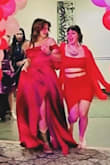 I loved the dress. I didn't have time to get it altered but I would definitely say it ran a bit longer than what I was expecting. I'm 5'5 and wore 1 1/2-inch heeled boots. Maybe I just don't know how to walk in a dress but either way, I loved it. It even had pockets! (A little more pink in natural sunlight, deeper red in the darker lighting). - Jamie F.