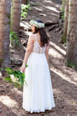 I ordered 3 dresses for my elopement and fell in love with this one! The lace back detail is stunning and it's a zip up so you don't need to worry about those buttons. I had to get it hemmed about 3 inches. It is very long and I didn't want it dragging on the floor. It's very flowy and doesn't hug my stomach or butt so I didn't have to worry about shapewear. I wore nude underwear and shorties that showed in other dresses but not this one because it has three layers! I wore a medium and it wasn't too tight. It was perfect. I felt so beautiful on my wedding day! - Aimee N.