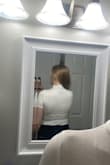 I sized down to an XS (pictured), as the S sat strangely on me (rippled at the torso). The shirt is very comfortable itself but extremely see-through, regardless of lighting. Everything underneath is visible. I will be returning, which is unfortunate- I loved the fit and feel, but it's just not wearable for me. - Nina L.