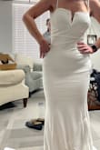 I bought this and one other dress for my elopement and reception, and this dress fit perfectly! I felt confident in the material, and it hugs in all the right places. The material is kinda stretchy, but unfortunately, it seems a little more snug than what I'm comfortable with - Jordan M.