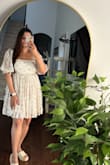 This dress is true to size, and the fabric is very light and flowy. Can definitely wear it in the summer/spring. The colors are really pretty. and I didn't have to wear a bra with it. It's not short- perfect length actually. - Roopal K.