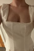 Super cute dress! The pearl detailing looks beautiful and not cheap. The material is comparable to the ones found on Revolve and comfortable for 1/2 the price! I ordered this for my June Bridal Shower, but I'm returning it because the straps were too loose and it's not worth it to try and alter. I wish the straps fit better because I would 100% be wearing this! Awkward photos but looked way better in person. Buy this! I bought a size small. I am 121lbs, 34B chest and 27 waist. An XS would have fit my shoulders better but would've been too tight on my waist area. The length is perfect. Beautiful dress and great quality!!! - Kelley G.
