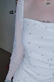 The fit is nice although it rides up super easy, I love the style, color, and fit but the pearls on the sleeves feel super weird on my skin. It is like freezing tingling droplets and due to that, I'll be returning it. - Rory C.