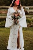 This dress is gorgeous and was perfect for our elopement. I wanted it to be simple, and elegant with a boho vibe. There is a seam around the waist. I just added a simple thin leather belt with a feather. I went barefoot and it was definitely long enough. I could have worn a low heel and still had enough length. It has a nice train in the back. I wish I had enough time to sew the liner to the slit opening but it wasn't that noticeable. I absolutely love this dress! - Tracey S.