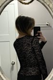 Cross over part in the front stays centered; it's nice and snug in the front- no need to worry about accidentally flashing someone from movement. I don't wear a bra with it because of the pretty back! Size Sm. - Sarah S.