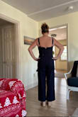 This is such a flattering jumpsuit! It fits perfectly! It is a little longer on me than the picture. I'm only 5'3 but with a pair of wedges, it's perfect! Can't wait to wear it at my daughter's college graduation in May. The only issue is the zipper is tough to zip up myself. It gets stuck at my mid-back.  Will need to have help or maybe will exchange for another to see if the zipper is better! But I definitely recommend it! - Amy S.