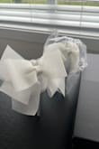 I'm typically a size 5.5. Most of the reviews said they run large so I ordered a 5. Way too small, the toe strap runs very small so I would recommend sizing up. I have re-ordered these in a size 6. Fingers crossed they fit. The bow is an interesting material; it's not tulle but more of a plastic. - Summer L.