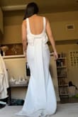 This is such a pretty and flattering dress. It's so sleek and modern! This would have been my dress if it wasn't for a few issues that I noticed. The bodice seems to have extra fabric so it had this fold that I can't seem to push out of the way. Also, I feel like the bow was a little weird and could have been pinched or ripped as opposed to a flat strip. The fabric is also a stretchy fabric, not exactly a bridal-type fabric. But overall, I loved the dress and felt so stunning in it. - Anna L.